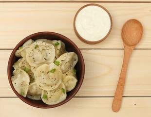 russian pelmeni on wood background