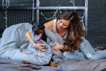 Woman in bed with big dog