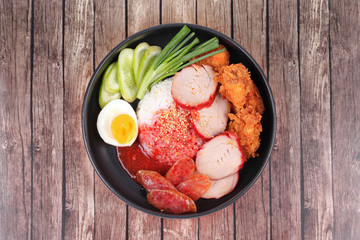 Jasmine rice with meat and boiled egg topped red sweet sauce .