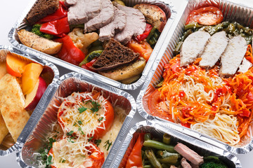 Healthy food take away in boxes, top view at wood