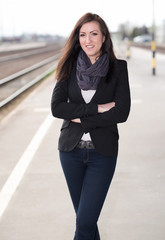 Beautiful woman standing at the train station