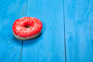 Doughnut on blue wooden table