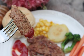 Grilled pork steak with  bread and ketchup.
