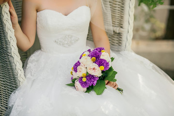 Bride holding delicate marriage bouquet