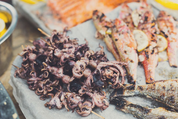 Seafood, fish, octopus grilled at barbecue