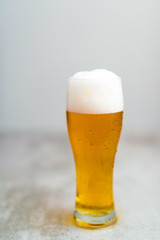 Glass of beer with gray background