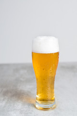 Glass of beer with gray background