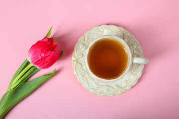 Obraz na płótnie Canvas tulip and a cup with tea