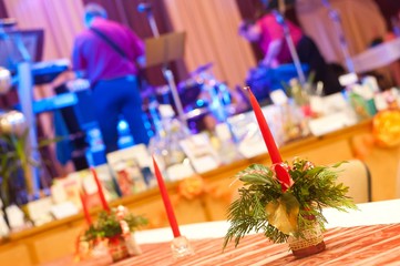 Decorated table with red candles in the party. Selective focus.