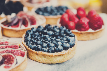 Fruit and berry tarts dessert tray assorted outdoors
