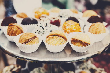 Different candies, cookies and biscuits on banquet table.