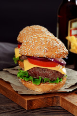 Cheeseburgers on wooden table with copy space