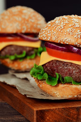 Cheeseburgers on wooden table with copy space
