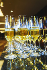 Several glasses of champagne bartender prepared for guests of festive events.