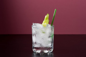gin and tonic cocktail drink with nice garnish cucumber straw ice