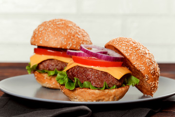Cheeseburgers on wooden table with copy space