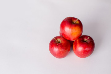 Red and green apples on a white background