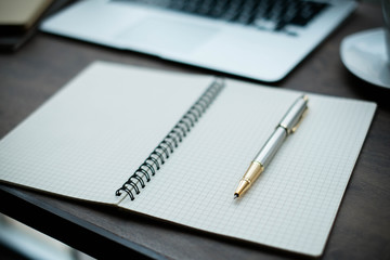 notebook and pen laptop on table