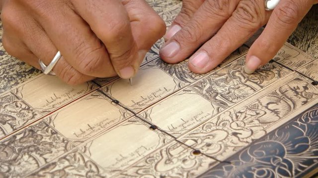 Local craftsmen make a calendar by scratching. Bali, Indonesia