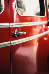 Close-up of door handle of old fire truck.