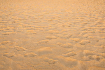 Fototapeta na wymiar texture of sand pattern on a beach in summer