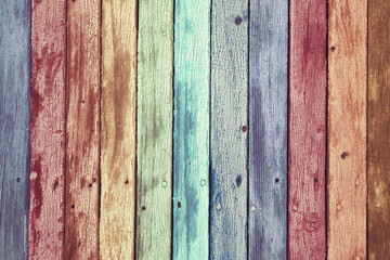 Rainbow colored aged wooden planks copy space background.