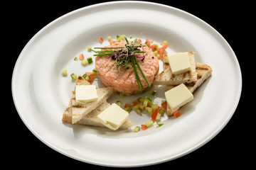 Fresh tartar with salmon, cucumber  on white plate,