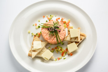 Fresh tartar with salmon, cucumber  on white plate,