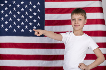 Caucasian little boy with American flag in background