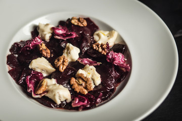 Beetroot salad with goat cheese and walnuts. Vegetarian food. Restaurant