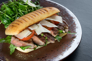 grilled steak medium fresh baked ciabatta sandwich beer