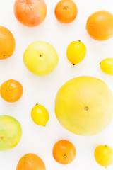 Fruits made of lemon, orange, grapefruit, sweetie and pomelo isolated on white background. Flat lay, top view.
