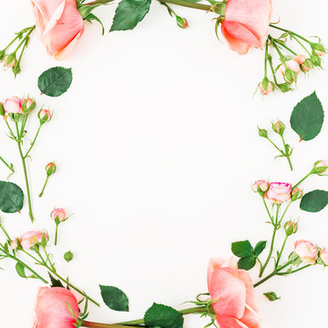 Floral frame with pink rose, leaves and buds on white background. Flat lay, top view. Frame background