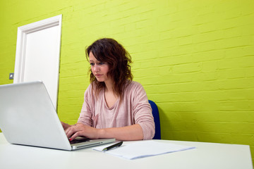 Close-up view of Young woman working at her desk