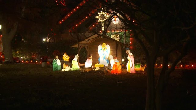 Zoom-in on an outdoor Nativity scene and a harp-playing angel