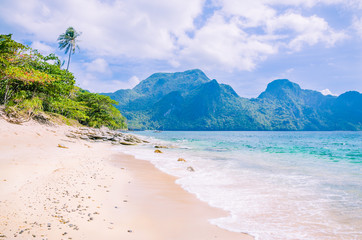 Stunning beach on Helicopter Island in the Bacuit archipelago in El Nido, Cadlao Island in Background, Palawan, Philippines