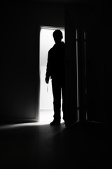 Fototapeta premium Full-length of burglar entering into house