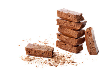 Pieces of milk aerated chocolate isolated on white