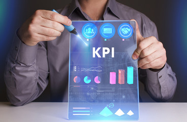 Business, Technology, Internet and network concept. Young businessman working on a virtual screen of the future and sees the inscription: KPI