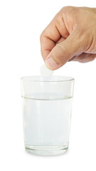 Man holding medicine on a glass of water.