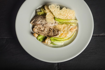 Tasty Caesar salad with chicken. Traditional food. Restaurant