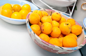 Yellow peaches in bowl at kitchen counter