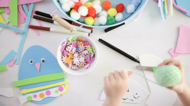 Step by step. Mother and daughter decorating paper Easter eggs