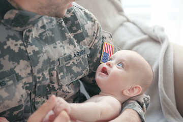 Military father holding his newborn baby