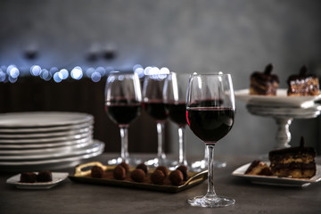 Wine and delicious chocolate desserts on table