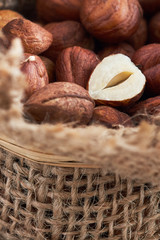 Peeled hazelnuts in burlap bag, close-up with copy space