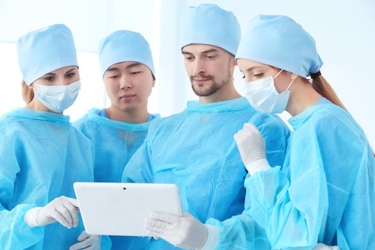 Young doctors with tablet computer in clinic