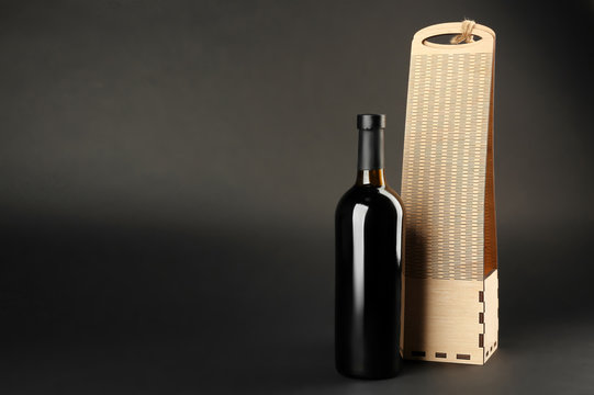 St. Valentine's Day concept. Wine bottle and gift box on dark background