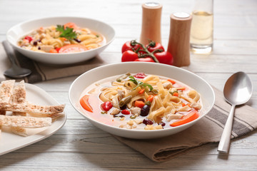 Chicken tortilla soup in plate on wooden table