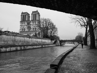 PARIS, FRANCE – MARCH 4TH 2017: A monochrome photograph taken under the Petit Pont bridge on the...